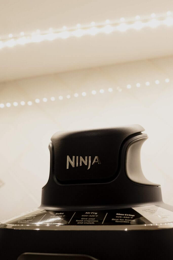 That Good Co Close-up of the top of a Ninja-brand kitchen appliance, with its logo in focus, showcasing craftsmanship that would impress even the connoisseurs at That Good Co.