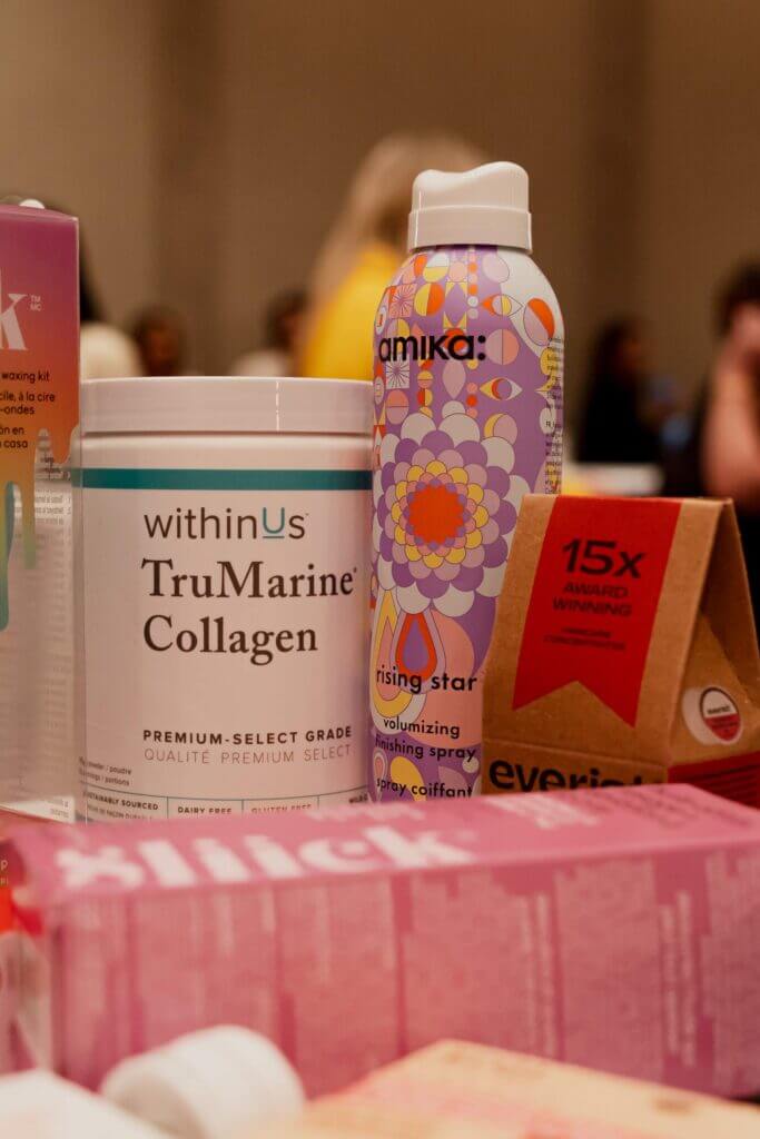 That Good Co A display from That Good Co showcases an array of beauty and health products, featuring collagen powder, volumizing spray, and various boxed items elegantly arranged on a table.